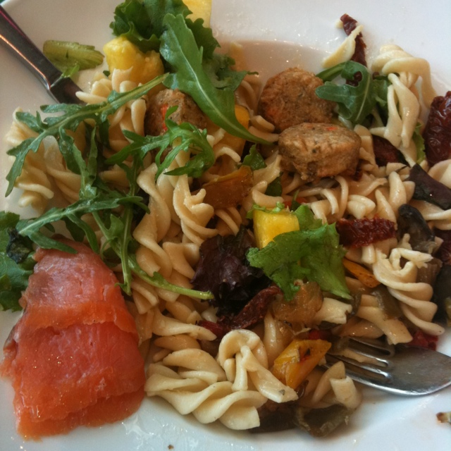fussili pasta with sun dried tomatoes, sausage, yellow peppers, arugula, and a small piece of raw salmon fussili pasta with sun dried tomatoes, sausage, yellow peppers, arugula, and a small piece of raw salmon